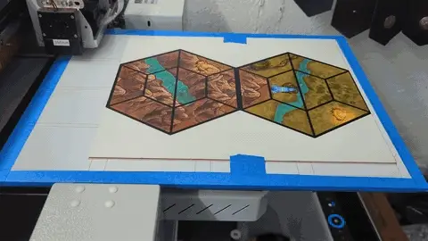 UV-printed modular board game hex tiles, printing and cutting pieces on the flatbed, and tile artwork prepped for print